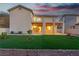 Expansive backyard featuring a covered patio, manicured artificial grass, and desert landscaping at 1136 Casady Hollow Ave, Henderson, NV 89012