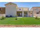 Backyard features an artificial lawn, a covered patio, and desert landscaping at 1136 Casady Hollow Ave, Henderson, NV 89012
