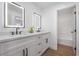 Modern bathroom featuring double sinks, granite countertops, and sleek fixtures at 1136 Casady Hollow Ave, Henderson, NV 89012