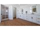 Bright bathroom showcasing double sinks, quartz counters, lighted mirrors, and stylish vanities at 1136 Casady Hollow Ave, Henderson, NV 89012