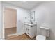 Contemporary half-bathroom with stylish vanity, marble countertop, and LED mirror for added appeal at 1136 Casady Hollow Ave, Henderson, NV 89012