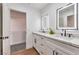 Elegant bathroom with double sinks, LED mirrors, and a doorway to the walk-in closet at 1136 Casady Hollow Ave, Henderson, NV 89012