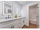 Modern bathroom with double sinks, LED mirrors, and a separate tub/shower area at 1136 Casady Hollow Ave, Henderson, NV 89012
