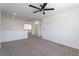 Bright carpeted bedroom with ceiling fan and view of the hallway at 1136 Casady Hollow Ave, Henderson, NV 89012