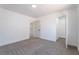 Bright bedroom showcasing carpet, white walls, and an open closet for extra storage at 1136 Casady Hollow Ave, Henderson, NV 89012