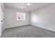 Bright bedroom featuring neutral carpet, white trim, and a window for natural lighting at 1136 Casady Hollow Ave, Henderson, NV 89012