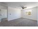 Carpeted bedroom featuring a ceiling fan and bright window with neighborhood views at 1136 Casady Hollow Ave, Henderson, NV 89012