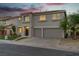 Two-story home with a stucco exterior, two-car garage, and well-maintained landscaping at 1136 Casady Hollow Ave, Henderson, NV 89012