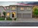 Charming two-story home with a three car garage, well-manicured lawn, and desert landscaping at 1136 Casady Hollow Ave, Henderson, NV 89012