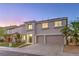 Charming two-story home featuring a well-manicured lawn, two-car garage, and desert landscaping at 1136 Casady Hollow Ave, Henderson, NV 89012