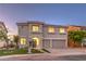 Charming two-story home featuring a well-manicured lawn, two-car garage, and desert landscaping at 1136 Casady Hollow Ave, Henderson, NV 89012