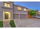 Charming two-story home featuring a well-manicured lawn, two-car garage, and desert landscaping at 1136 Casady Hollow Ave, Henderson, NV 89012
