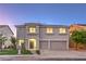 Charming two-story home featuring a well-manicured lawn, two-car garage, and desert landscaping at 1136 Casady Hollow Ave, Henderson, NV 89012