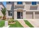 Inviting entryway featuring a decorative security door, manicured lawn, and lovely landscaping at 1136 Casady Hollow Ave, Henderson, NV 89012