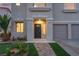 Inviting front entrance with stone pathway, decorative door, and desert landscaping at 1136 Casady Hollow Ave, Henderson, NV 89012