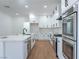 Modern kitchen featuring white cabinets, stainless steel appliances, and a spacious center island at 1136 Casady Hollow Ave, Henderson, NV 89012