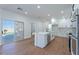 Bright, white kitchen featuring stainless steel appliances and an island with barstool seating at 1136 Casady Hollow Ave, Henderson, NV 89012