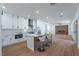 Beautiful kitchen features white cabinets, marble countertops, and a modern island with seating at 1136 Casady Hollow Ave, Henderson, NV 89012