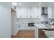 Bright kitchen with white cabinets, quartz countertops, stainless appliances, and wood-look flooring at 1136 Casady Hollow Ave, Henderson, NV 89012