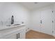 Functional laundry room with sink, storage cabinets, and a modern design at 1136 Casady Hollow Ave, Henderson, NV 89012