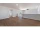 Open living room highlighting wood-style floors, balcony access and a ceiling fan fixture at 1136 Casady Hollow Ave, Henderson, NV 89012