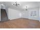 Bright living room with staircase, modern light fixtures, and ample space for entertaining at 1136 Casady Hollow Ave, Henderson, NV 89012