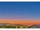 Scenic view of city lights and a colorful sunset sky over the mountains from a rooftop at 1136 Casady Hollow Ave, Henderson, NV 89012