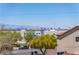 Neighborhood view showcasing a home, trees, and a city skyline in the distance at 1136 Casady Hollow Ave, Henderson, NV 89012