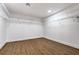 Spacious walk-in closet featuring a hardwood floor and white shelving for optimal storage solutions at 1136 Casady Hollow Ave, Henderson, NV 89012