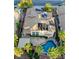 Aerial view showing a house with solar panels, pool, lush landscaping, and shaded patio at 11550 Velicata Ct, Las Vegas, NV 89138