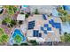 Aerial view of a home featuring solar panels, a tile roof, and a private backyard pool at 11550 Velicata Ct, Las Vegas, NV 89138