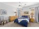 Bright bedroom featuring a ceiling fan, a bed, a chair, and bedside tables with lamps at 11550 Velicata Ct, Las Vegas, NV 89138
