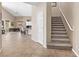Entryway featuring tiled floors, stairwell and partial view into the living room and kitchen at 11550 Velicata Ct, Las Vegas, NV 89138