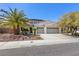 Exterior of a home showing a well-manicured front yard and a three-car garage at 11550 Velicata Ct, Las Vegas, NV 89138
