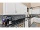 Stylish kitchen with dark countertops, stainless steel appliances, and updated cabinetry at 11550 Velicata Ct, Las Vegas, NV 89138