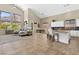 Open-concept kitchen and living area with high ceilings and bright windows, perfect for modern living at 11550 Velicata Ct, Las Vegas, NV 89138
