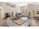 Bright and airy living space featuring a large island, modern design, and seamless flow to the outdoors at 11550 Velicata Ct, Las Vegas, NV 89138
