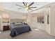 Spacious main bedroom features a tray ceiling with fan, neutral carpeting, and lots of natural light at 11550 Velicata Ct, Las Vegas, NV 89138
