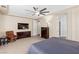 This is another view of the spacious bedroom featuring a large screen television and a neutral color palette at 11550 Velicata Ct, Las Vegas, NV 89138
