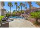 Inviting backyard pool and spa surrounded by lush landscaping and lounge chairs, perfect for outdoor relaxation at 11550 Velicata Ct, Las Vegas, NV 89138