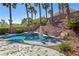 Inviting pool and spa surrounded by tropical plants and mature landscaping, perfect for enjoying the outdoor lifestyle at 11550 Velicata Ct, Las Vegas, NV 89138