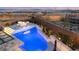 Aerial view of backyard pool, patio, and fire pit with turf accents, surrounded by desert landscaping at 11943 Rockview Point St, Las Vegas, NV 89138