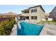 Modern backyard with swimming pool, lounge chairs, and patio with decorative turf inserts and mountain views at 11943 Rockview Point St, Las Vegas, NV 89138