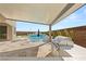 Outdoor kitchen featuring a grill and island top with a patio, lounge chairs and pool views at 11943 Rockview Point St, Las Vegas, NV 89138