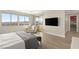 Sunlit bedroom features an accent chair and large windows with views; access to walk-in closet and balcony at 11943 Rockview Point St, Las Vegas, NV 89138