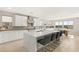 Modern kitchen featuring white cabinets, a large island with seating, and a view of the outdoor space at 11943 Rockview Point St, Las Vegas, NV 89138