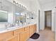 Bright bathroom featuring a double sink vanity with modern light fixtures and separate shower at 1199 Golf Club, Laughlin, NV 89029