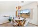 Bright dining room with a view of the golf course, modern chandelier, and seating for four at 1199 Golf Club, Laughlin, NV 89029