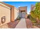 Welcoming front entrance with desert landscaping, a gated walkway, and a cozy porch at 1199 Golf Club, Laughlin, NV 89029