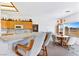 Bright kitchen with bar seating, a dining table, and a view of the golf course at 1199 Golf Club, Laughlin, NV 89029